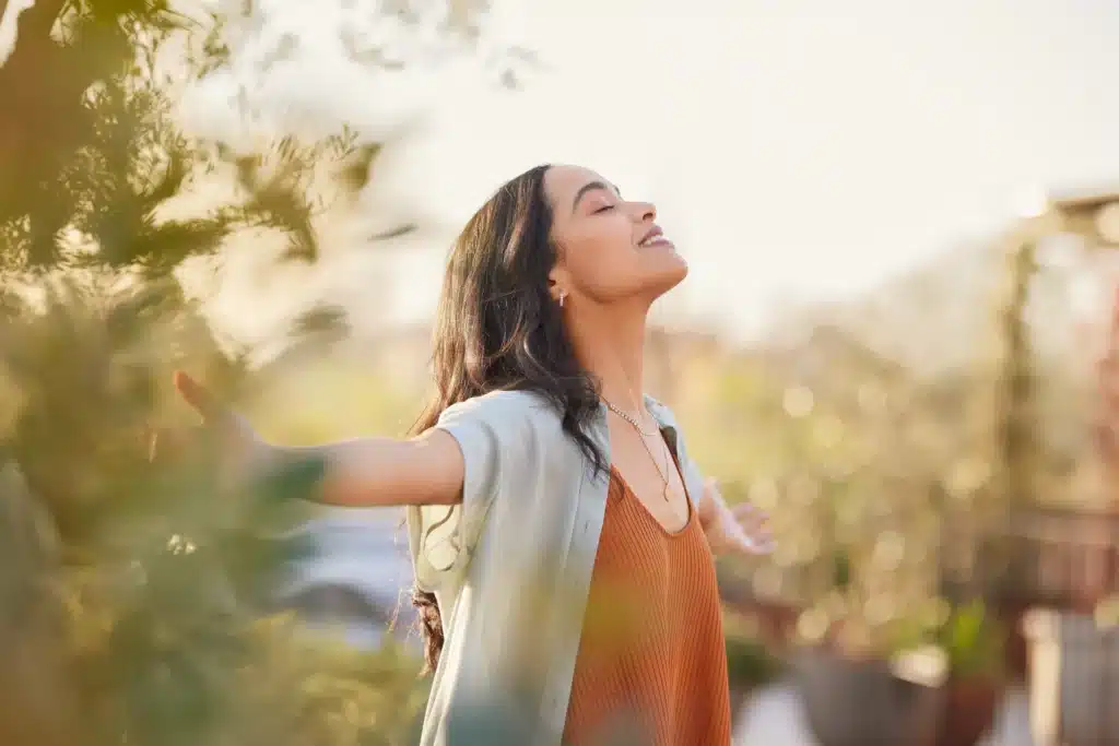 Woman embracing freedom and healing outdoors during residential addiction treatment in California